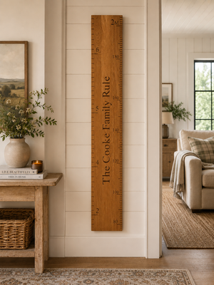 Wooden family rule chart on a wall in a home interior.